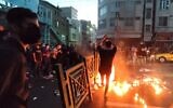 A picture obtained by AFP outside Iran on September 21, 2022, shows Iranian demonstrators taking to the streets of the capital Tehran during a protest for Mahsa Amini, days after she died in police custody. (AFP)
