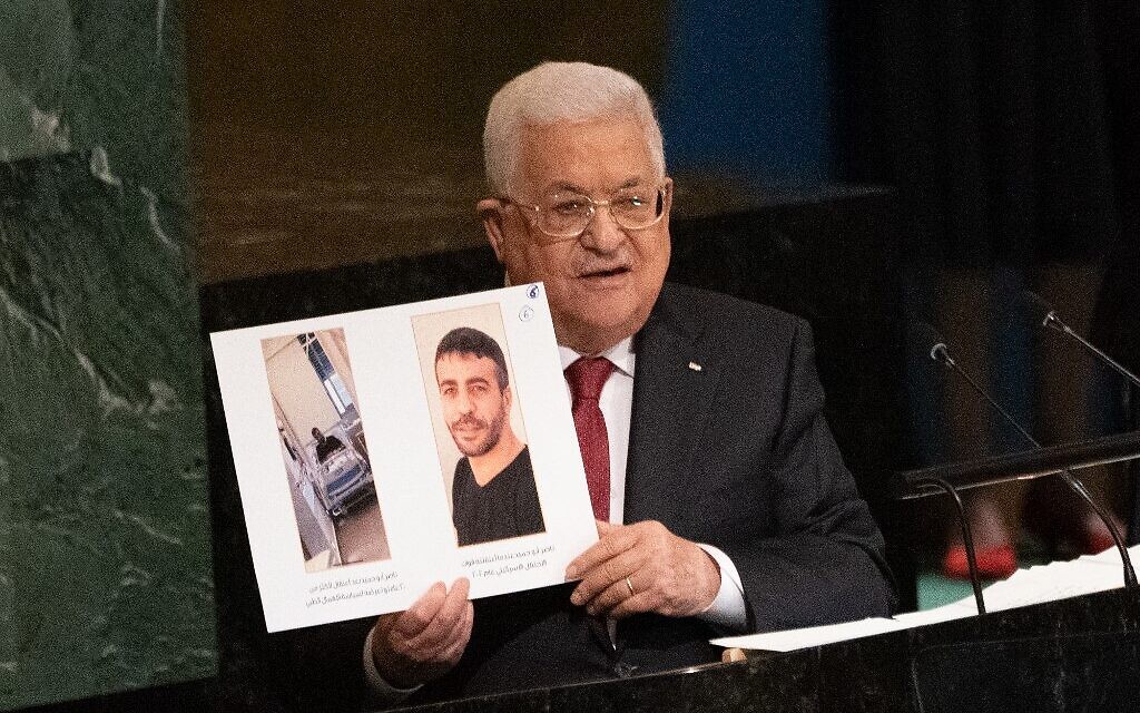Palestinian Authority President Mahmoud Abbas holds up photographs of jailed Palestinian terrorist Nasser Abu Hamid, who is dying of cancer, as he addresses the 77th session of the United Nations General Assembly in New York on September 23, 2022. (Bryan R. Smith/AFP) Palestinian Authority President Mahmoud Abbas holds up photographs of jailed Palestinian terrorist Nasser Abu Hamid, who is dying of cancer, as he addresses the 77th session of the United Nations General Assembly in New York on September 23, 2022. (Bryan R. Smith/AFP)