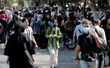 A woman walks with other shoppers at the Grand Bazaar in Iran's capital Tehran on September 28, 2022. (ATTA KENARE / AFP)