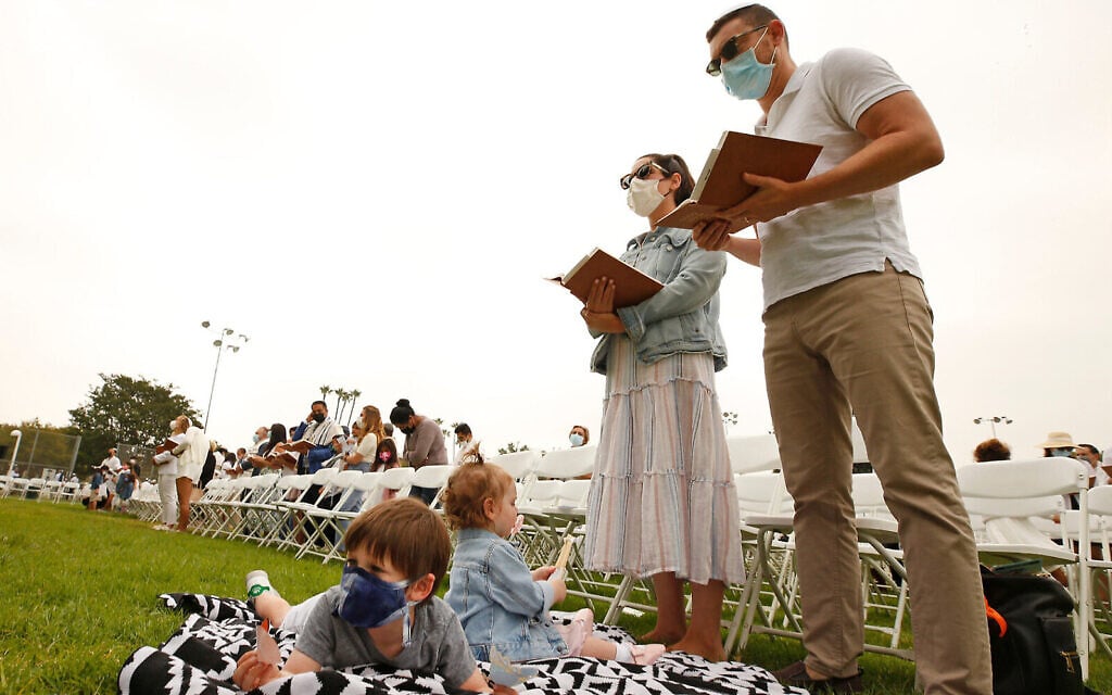 A family prays during an outdoor Yom Kippur service at Sinai Temple during the coronavirus pandemic, undated. (Getty Images via Al Seib/JTA) A family prays during an outdoor Yom Kippur service at Sinai Temple during the coronavirus pandemic, undated. (Getty Images via Al Seib/JTA)