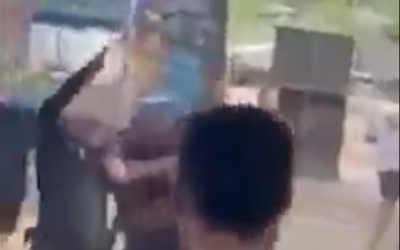 A policeman firing his handgun into the air while being attacked by a ravers at an illegal party in Migdal, northern Israel, September 2, 2022. (Screengrab/Twitter, used in accodance with Clause 27a of the Copyright Law)