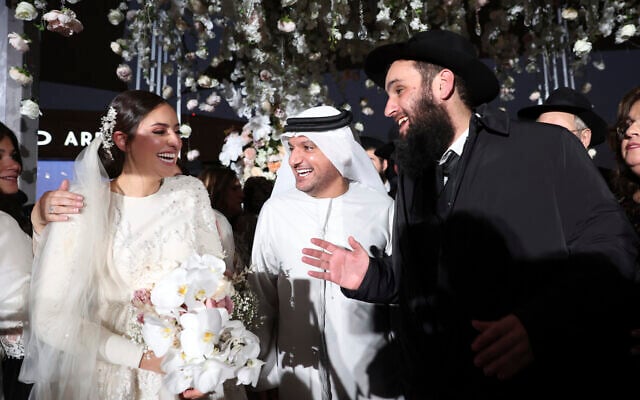 An Emirati government official, center, greets Lea Hadad, left, and UAE Rabbi Levi Duchman during their wedding in Abu Dhabi, UAE, Sept. 14, 2022. (Sami Sasso) An Emirati government official, center, greets Lea Hadad, left, and UAE Rabbi Levi Duchman during their wedding in Abu Dhabi, UAE, Sept. 14, 2022. (Sami Sasso)