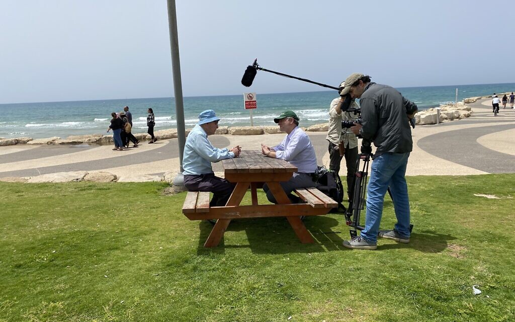 Shaul Ladany (seated, left) and Jeremy Schaap (seated, right) in Tel Aviv. (Frank Saraceno/ via JTA)