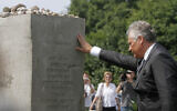 Former Polish President Alekdander Kwasniewski touches a memorial for slain Jews at a ceremony marking 70 years since Polish villagers murdered hundreds of their Jewish neighbors during World War II, in Jedwabne, Poland, July 10, 2011. (AP Photo/Czarek Sokolowski)