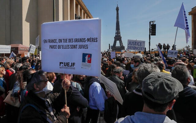 Illustrative: A man holds a placard that reads, 'In France grandmothers are killed because they are Jews,' during a protest organized by Jewish associations, who say justice has not been done for the killing of French Jewish woman Sarah Halimi, at Trocadero Plaza near Eiffel Tower in Paris, April 25, 2021. (AP Photo/Michel Euler) Illustrative: A man holds a placard that reads, 'In France grandmothers are killed because they are Jews,' during a protest organized by Jewish associations, who say justice has not been done for the killing of French Jewish woman Sarah Halimi, at Trocadero Plaza near Eiffel Tower in Paris, April 25, 2021. (AP Photo/Michel Euler)
