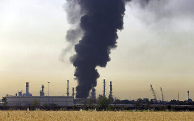 Illustrative: A dark plume of smoke rises up from a main oil refinery south of Tehran, Iran, June 3, 2021. (AP Photo/Ebrahim Noroozi)
