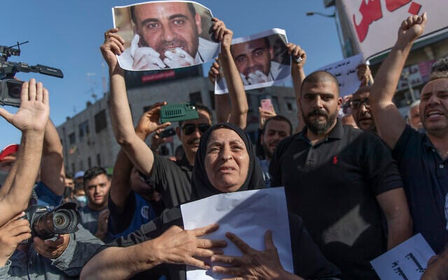 Maryam Banat, 67, mother of Palestinian Authority outspoken critic Nizar Banat holds a poster with his picture while attending a rally protesting his death, in the West Bank city of Ramallah, Saturday, July 3, 2021. (AP Photo/Nasser Nasser) Maryam Banat, 67, mother of Palestinian Authority outspoken critic Nizar Banat holds a poster with his picture while attending a rally protesting his death, in the West Bank city of Ramallah, Saturday, July 3, 2021. (AP Photo/Nasser Nasser)