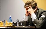 Magnus Carlsen of Norway competes during the FIDE World Championship at Dubai Expo 2020 in Dubai, United Arab Emirates, December 10, 2021. (AP Photo/Jon Gambrell)