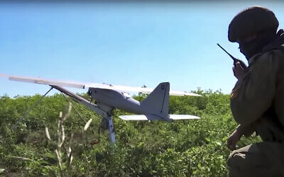 Illustrative: This handout photo taken from video released by Russian Defense Ministry Press Service on August 8, 2022, shows a Russian serviceman preparing a Orlan-10 reconnaissance drone to launch at an undisclosed location. (Russian Defense Ministry Press Service photo via AP)