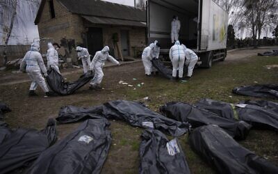 Volunteers load on a truck corpses of civilians killed in Bucha to be taken to a morgue for investigation, in the outskirts of Kyiv, Ukraine, April 12, 2022. (Rodrigo Abd/AP) Volunteers load on a truck corpses of civilians killed in Bucha to be taken to a morgue for investigation, in the outskirts of Kyiv, Ukraine, April 12, 2022. (Rodrigo Abd/AP)