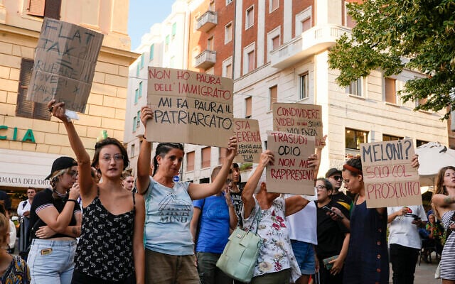 People stage a protest as right-wing party Brothers of Italy's leader Giorgia Meloni addresses a rally in Ancona, Italy, Aug. 23, 2022. (AP Photo/Domenico Stinellis) People stage a protest as right-wing party Brothers of Italy's leader Giorgia Meloni addresses a rally in Ancona, Italy, Aug. 23, 2022. (AP Photo/Domenico Stinellis)
