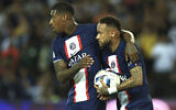 PSG's Presnel Kimpembe, left, and PSG's Neymar celebrate after scoring during the French League One soccer match between Paris Saint-Germain and Monaco at the Parc des Princes in Paris, France, August 28, 2022. (AP Photo/Aurelien Morissard)