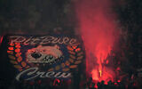 Inter Milan fans light flares as they cheer during a Serie A soccer match between Inter Milan and Cremonese at the San Siro stadium in Milan, Italy, Tuesday, August 30, 2022. (AP Photo/Luca Bruno)