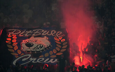 Inter Milan fans light flares as they cheer during a Serie A soccer match between Inter Milan and Cremonese at the San Siro stadium in Milan, Italy, Tuesday, August 30, 2022. (AP Photo/Luca Bruno)