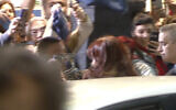 This still image taken from a video provided by Television Publica Argentina shows a man pointing a gun at Argentina´s Vice President Cristina Fernandez de Kirchner during an event in front of her home in the Recoleta neighborhood of Buenos Aires, Argentina, Thursday, Sept. 1, 2022. (Television Publica Argentina via AP)