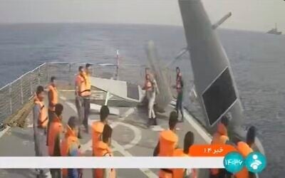 In this frame grab from Iranian state television, Iranian navy sailors throw an American sea drone overboard in the Red Sea on September 1, 2022. (Iranian state television via AP)