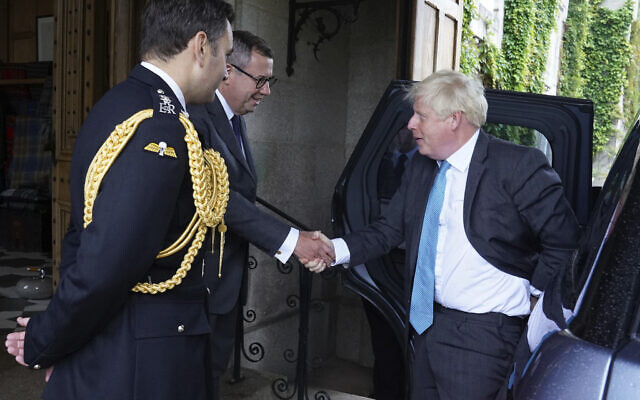 Outgoing Prime Minister Boris Johnson arrives at Balmoral and are greeted by Queen's Equerry Lieutenant Colonel Tom White, left and Queen's private Secretary Sir Edward Young for an audience with Britain's Queen Elizabeth II to formally resign as Prime Minister, in Aberdeenshire, Scotland, Tuesday, September 6, 2022. (Andrew Milligan/Pool Photo via AP) Outgoing Prime Minister Boris Johnson arrives at Balmoral and are greeted by Queen's Equerry Lieutenant Colonel Tom White, left and Queen's private Secretary Sir Edward Young for an audience with Britain's Queen Elizabeth II to formally resign as Prime Minister, in Aberdeenshire, Scotland, Tuesday, September 6, 2022. (Andrew Milligan/Pool Photo via AP)