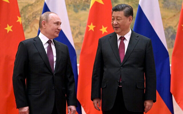 Chinese President Xi Jinping, right, and Russian President Vladimir Putin talk to each other during their meeting in Beijing on Feb. 4, 2022. Putin and Xi will meet next week at a summit in Uzbekistan, a Russian official said Wednesday, Sept. 7. (Alexei Druzhinin, Sputnik, Kremlin Pool Photo via AP, File)