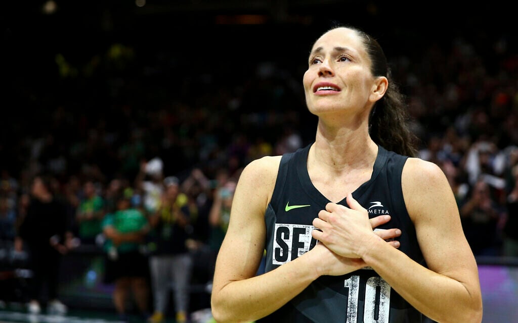 Seattle Storm guard Sue Bird puts her hands over her heart as she acknowledges fans chanting her name after her team was eliminated from the playoffs by the Las Vegas Aces in Game 4 of a WNBA basketball playoff semifinal, making it her last career game, September 6, 2022, in Seattle. The Aces beat the Storm 97-92 to advance to the WNBA Finals. (AP Photo/Lindsey Wasson)
