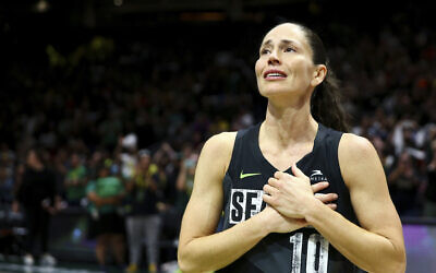 Seattle Storm guard Sue Bird puts her hands over her heart as she acknowledges fans chanting her name after her team was eliminated from the playoffs by the Las Vegas Aces in Game 4 of a WNBA basketball playoff semifinal, making it her last career game, September 6, 2022, in Seattle. The Aces beat the Storm 97-92 to advance to the WNBA Finals. (AP Photo/Lindsey Wasson)