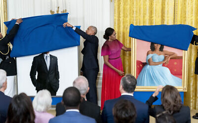 Former US president Barack Obama and former first lady Michelle Obama unveil their official White House portraits during a ceremony in the East Room of the White House, in Washington, Sept. 7, 2022. (Andrew Harnik/AP)
