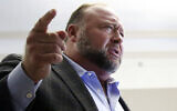 Alex Jones talks to media during a midday break in his trial at the Travis County Courthouse in Austin, Texas, on July 26, 2022. (Briana Sanchez/Austin American-Statesman via AP, Pool)