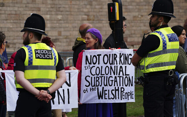 People protest ahead of the Accession Proclamation Ceremony at Cardiff Castle, Wales, publicly proclaiming King Charles III as the new monarch, Sunday Sept. 11, 2022. (Ben Birchall/PA via AP)