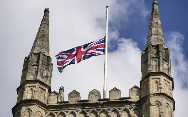 The Union Jack is set on half-mast at a church outside Windsor Castle, in Windsor, England, September 11, 2022. (Martin Meissner/AP)