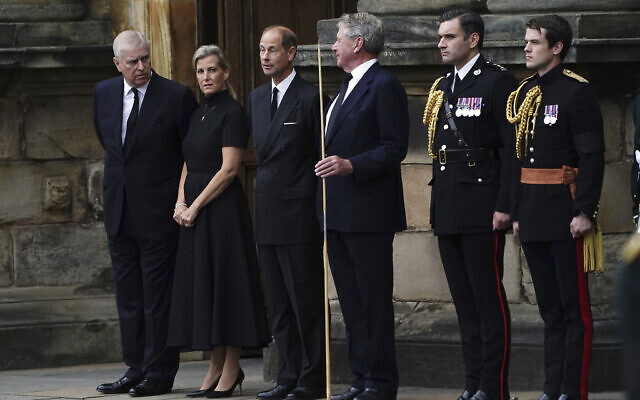 Britain's Prince Andrew, left, Sophie, Countess of Wessex, and Prince Edward, third left, await the arrival of the hearse carrying the coffin of Queen Elizabeth II, draped with the Royal Standard of Scotland, as it completes its journey from Balmoral to the Palace of Holyroodhouse in Edinburgh, Scotland, September 11, 2022. (Aaron Chown/Pool via AP)