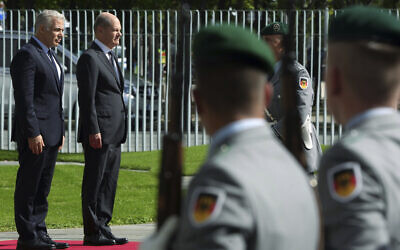 German Chancellor Olaf Scholz, on podium right, welcomes Israeli Prime Minister Yair Lapid, on podium left, with military honors for a meeting at the chancellery in Berlin, Germany, September 12, 2022. (AP Photo/Michael Sohn)