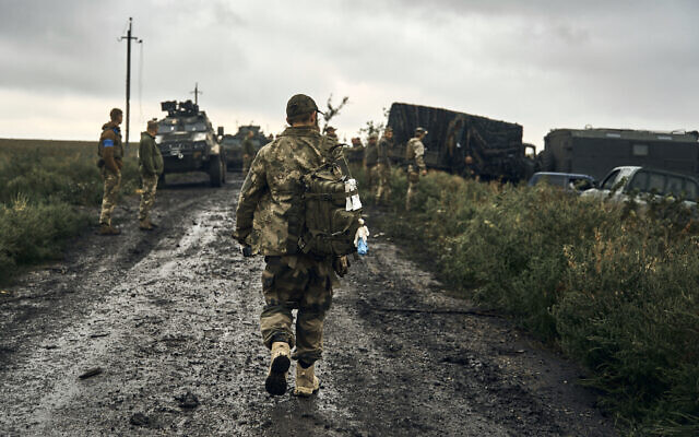 Ukrainian soldiers stand on the road in the freed territory of the Kharkiv region, Ukraine, September 12, 2022. (AP Photo/ Kostiantyn Liberov) Ukrainian soldiers stand on the road in the freed territory of the Kharkiv region, Ukraine, September 12, 2022. (AP Photo/ Kostiantyn Liberov)