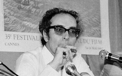 Film director Jean-Luc Godard smokes at Cannes festival, France on May 25, 1982. (AP Photo/Jean-Jacques Levy, File)