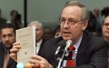 Independent Counsel Kenneth Starr holds a copy of his report while testifying on Capitol Hill Thursday Nov. 19, 1998, before the House Judiciary Committee's impeachment hearing. 
 (AP/Doug Mills)