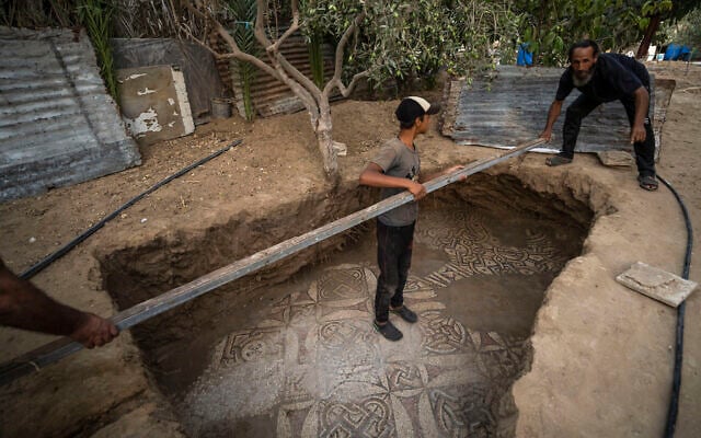Palestinians clean around a Byzantine-era mosaic floor that was uncovered recently by a farmer in Bureij in central Gaza Strip, Sept. 5, 2022. (AP Photo/Fatima Shbair) Palestinians clean around a Byzantine-era mosaic floor that was uncovered recently by a farmer in Bureij in central Gaza Strip, Sept. 5, 2022. (AP Photo/Fatima Shbair)