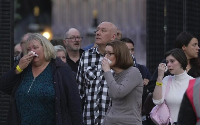 People cry as they leave the Queen Elizabeth II's lying in state in London, September 14, 2022. (AP Photo/Kin Cheung)