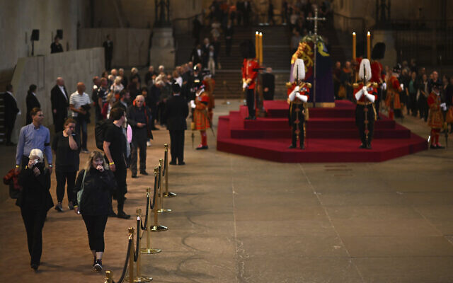 Members of the public pay their respects as they pass the coffin of Queen Elizabeth II as it Lies in State inside Westminster Hall, London, September 14, 2022, where it will lie in state ahead of her funeral on Monday. (Ben Stansall/Pool Photo via AP) Members of the public pay their respects as they pass the coffin of Queen Elizabeth II as it Lies in State inside Westminster Hall, London, September 14, 2022, where it will lie in state ahead of her funeral on Monday. (Ben Stansall/Pool Photo via AP)