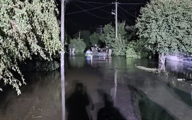 Rescuers help people evacuate from a flooded area after what Ukrainian officials said was a Russian missile attack hit and damaged the dam and a nearby pumping station in Kryvyi Rih, Ukraine, September 14, 2022. (Ukrainian Emergency Service via AP Photo) Rescuers help people evacuate from a flooded area after what Ukrainian officials said was a Russian missile attack hit and damaged the dam and a nearby pumping station in Kryvyi Rih, Ukraine, September 14, 2022. (Ukrainian Emergency Service via AP Photo)