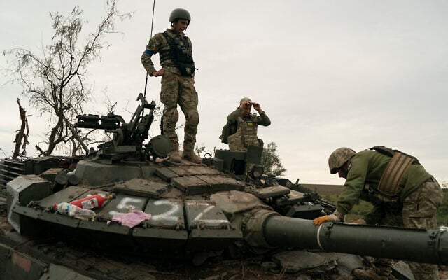 Ukrainian servicemen stand atop a destroyed Russian tank in a retaken area near the border with Russia in Kharkiv region, Ukraine, September 17, 2022. (AP Photo/Leo Correa) Ukrainian servicemen stand atop a destroyed Russian tank in a retaken area near the border with Russia in Kharkiv region, Ukraine, September 17, 2022. (AP Photo/Leo Correa)