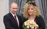 Russian President Vladimir Putin, left, and Russian pop singer Alla Pugacheva pose for a photo during an awards ceremony in Moscow's Kremlin in Moscow, Russia, December 22, 2014. (Alexei Druzhinin, Sputnik, Kremlin Pool Photo via AP, File)