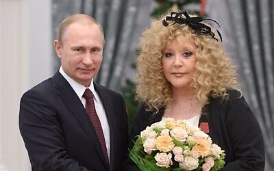 Russian President Vladimir Putin, left, and Russian pop singer Alla Pugacheva pose for a photo during an awards ceremony in Moscow's Kremlin in Moscow, Russia, December 22, 2014. (Alexei Druzhinin, Sputnik, Kremlin Pool Photo via AP, File)