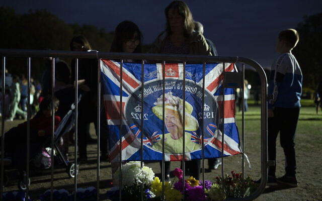 Members of the public are seen outside Windsor Castle by floral tributes for the late Queen Elizabeth II in Windsor, England, September 18, 2022. (AP Photo/Jon Super)