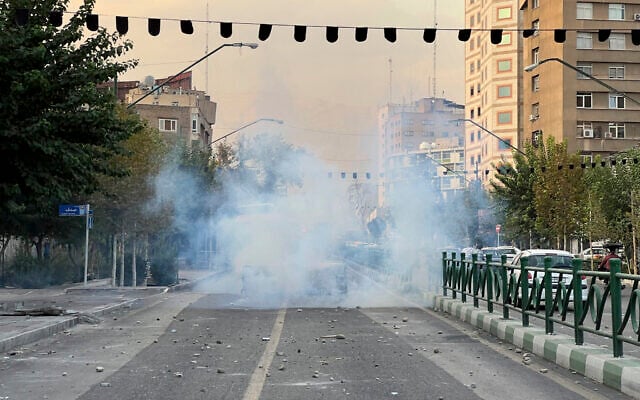 In this Tuesday, Sept. 20, 2022, photo taken by an individual not employed by the Associated Press and obtained by the AP outside Iran, tear gases are thrown by the police during a protest over the death of a young woman who had been detained for violating the country's conservative dress code, in downtown Tehran, Iran. Iran faced international criticism on Tuesday over the death of a woman held by its morality police, which ignited three days of protests, including clashes with security forces in the capital and other unrest that claimed at least three lives. (AP Photo)