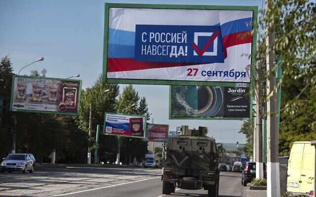 FILE - A military vehicle drives along a street with a billboard that reads: "With Russia forever, September 27", prior to a referendum in Luhansk, Luhansk People's Republic controlled by Russia-backed separatists, eastern Ukraine, September 22, 2022. (AP Photo/File) FILE - A military vehicle drives along a street with a billboard that reads: "With Russia forever, September 27", prior to a referendum in Luhansk, Luhansk People's Republic controlled by Russia-backed separatists, eastern Ukraine, September 22, 2022. (AP Photo/File)