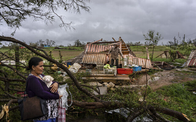 Mercedes Valdez holds her dog Kira as she waits for transportation after losing her home to Hurricane Ian in Pinar del Rio, Cuba, Sept. 27, 2022. (AP Photo/Ramon Espinosa) Mercedes Valdez holds her dog Kira as she waits for transportation after losing her home to Hurricane Ian in Pinar del Rio, Cuba, Sept. 27, 2022. (AP Photo/Ramon Espinosa)