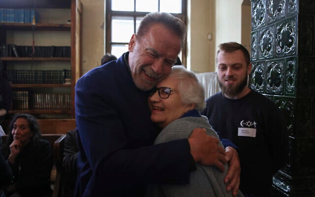 Arnold Schwarzenegger, left, hugs Holocaust survivor Lydia Maksimovicz, right, in Oswiecim, Poland, September 28, 2022. (AP Photo/Michal Dyjuk)