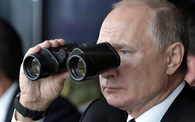 Russian President Vladimir Putin holds binoculars while watching the military exercises Center-2019 at Donguz shooting range near Orenburg, Russia, in Sept. 20, 2019. (Alexei Nikolsky, Sputnik, Kremlin Pool Photo via AP)