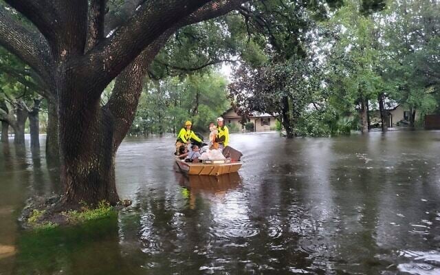 In this photo provided by the Orange County Fire Rescue's Public Information Office, firefighters in Orange County, Florida., help people stranded by Hurricane Ian, September 29, 2022. (Orange County Fire Rescue's Public Information Office via AP)