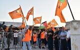 Balad supporters wave the Palestinian and the party flag at campaign launch in Baqa al-Gharbiya on September 24, 2022. (Courtesy)