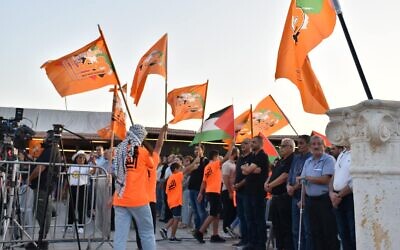 Balad supporters wave the Palestinian and the party flag at campaign launch in Baqa al-Gharbiya on September 24, 2022. (Courtesy) Balad supporters wave the Palestinian and the party flag at campaign launch in Baqa al-Gharbiya on September 24, 2022. (Courtesy)