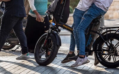 Illustrative -- Teenagers ride on an electrical bike in Jerusalem on on November 14, 2019 (Olivier Fitoussi/Flash90)